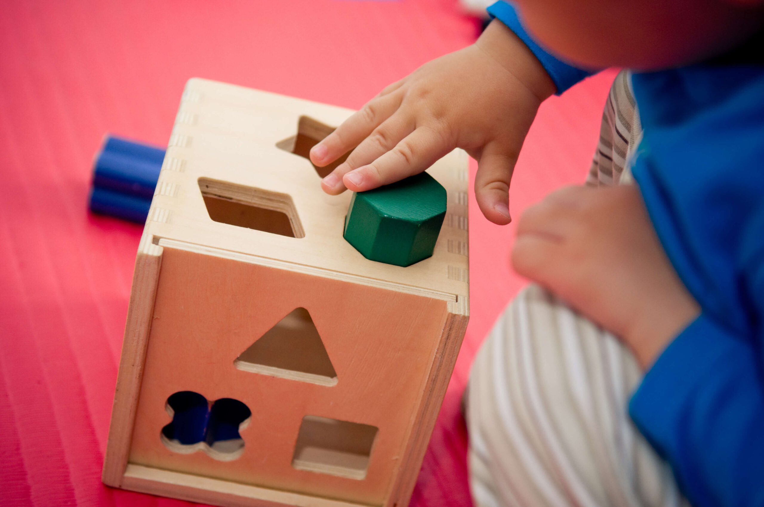 Child playing with blocks and shapes