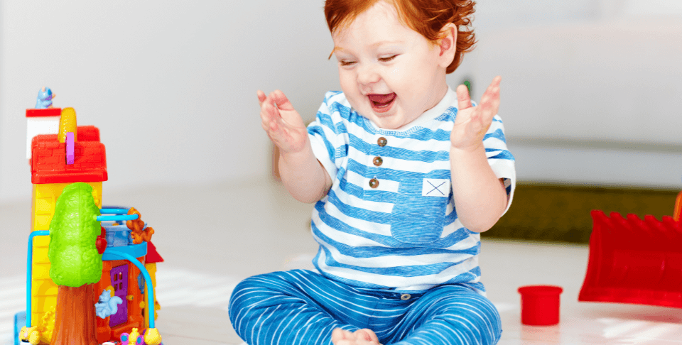 Baby with red hair clapping